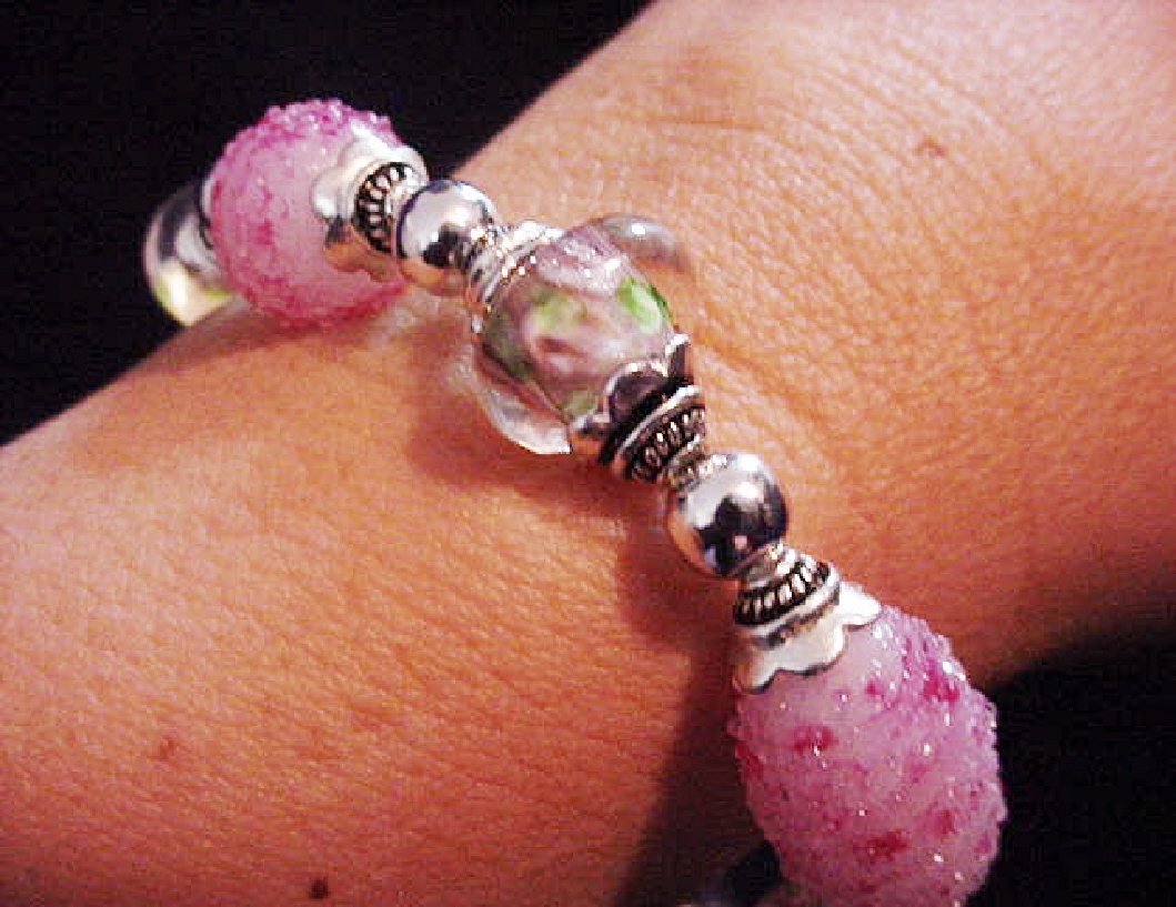 Handcrafted Jewelry Pink Glass Beads Bracelet-Handcrafted with Pink and White Large oval and medium round Glass beads. Transparent Lampwork pink roses flower glass beads are used for a floral and romantic look. Embellished with Silver plated beads and findings. Stretch cord is used for bracelet band. Beautiful and Elegant!